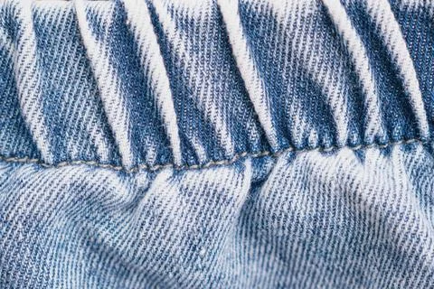 Horizontal macro close up shot of a blue jeans denim waistband with elastic.. Stock Photos