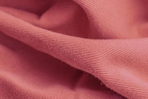 Horizontal macro close up shot of a soft pinkish coral woven cotton fabric .. Stock Photos