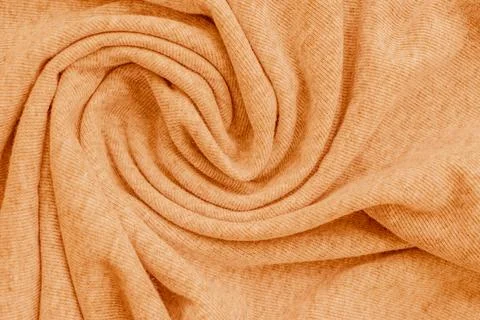 Horizontal macro close up of a soft pastel orange knitted fabric material t.. Stock Photos