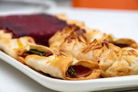 Horizontal macro view of canaps and sachets with vegetables and ham and some  Stock Photos