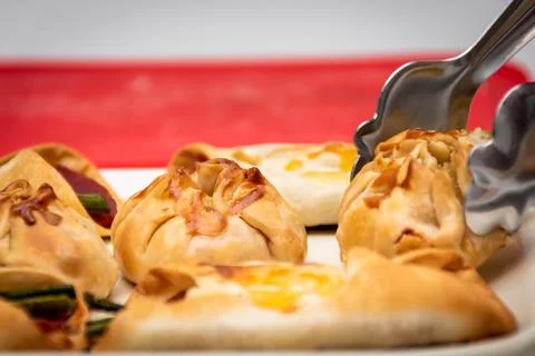 Horizontal macro view of canaps and sachets with vegetables and ham and a few Stock Photos