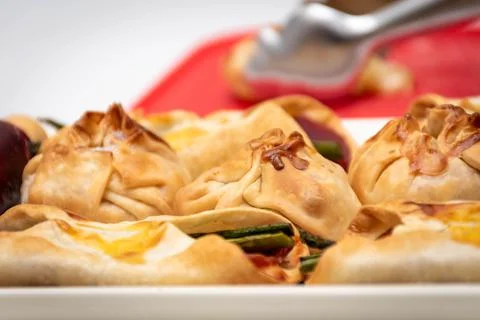 Horizontal macro view of canaps and sachets with vegetables and ham and a pai Stock Photos