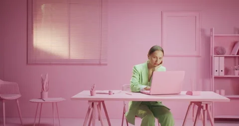Horizontal moving shot of sad and tired young female worker at pink workplace Stock Footage 162416453