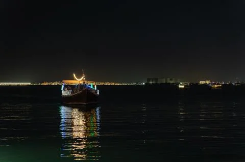 Horizontal Night View of Illuminated Qatari Dhow Boat on Doha Corniche Stock Photos