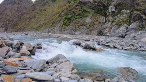 Horizontal over look to river water surged rapidly with speed raced downstream l Stock Footage 265492100