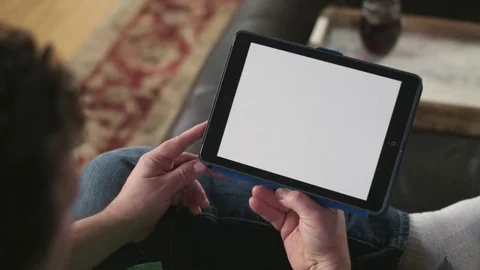 Horizontal over the shoulder shot of man holding a tablet Stock Footage 71343793