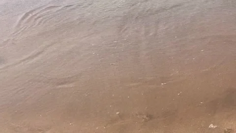 Horizontal Overhead View of Shallow Sea Water Washing over Sandy Shore Stock Footage 340774816