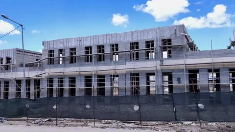 Horizontal pan from left to right showing a row of buildings under construction Vídeos de archivo 333908630