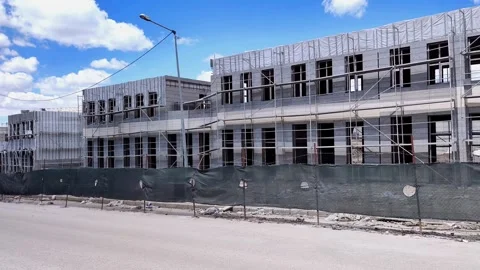 Horizontal pan from left to right showing a row of buildings under construction Vídeos de archivo 333908726