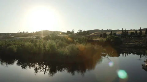 Horizontal pan shot of river leading up to a dam in Fresno California 2 動画素材 64796359