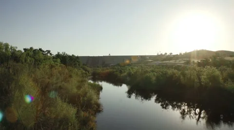 Horizontal pan shot of river leading up to a dam in Fresno California Stock Footage 64796473