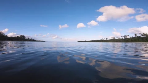 Horizontal pane view above water surface look out to Avana harbor passage with i Stock Footage 253458832