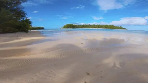 Horizontal pane view of beach sandy side look out to islets and calm relax turqu Stock Footage 253461563