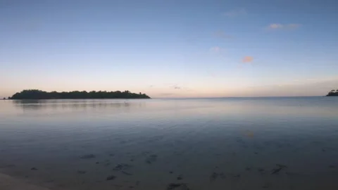 Horizontal pane view beach side during low tide sunset time with ocean water ref Stock Footage 252179445