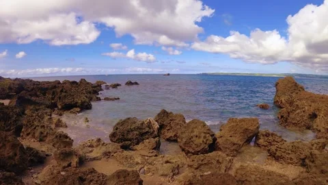 Horizontal pane view left to right standing on coral rocky shore look out to the Stock-Footage 279141666