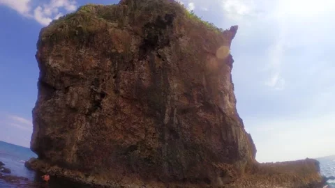 Horizontal pane view left to right look up to Chuanfan Rock at the ocean sea sid Stock Footage 312401460