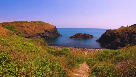 Horizontal pane view look out to an islet in the middle of the bay to blue calm  Stock Footage 238498256