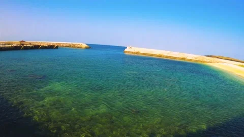 Horizontal pane view look out to embankment harbor to small sandy beach to Dongj Stock Footage 238500717