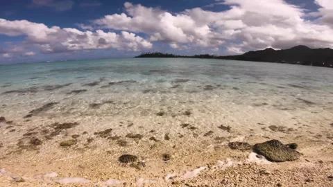 Horizontal pane view look out to pacific horizon of sandy rocky beach of beautif Video stock 250401338