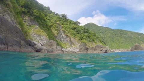 Horizontal pane view look out to rocky seashore coastline with boulder of rocks  Stock Footage 263019564