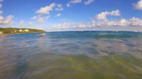 Horizontal pane view look out to ocean sea horizon with people swimming relaxing Stock Footage 279141804