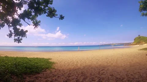 Horizontal pane view look out to a peaceful beach from land to ocean horizon wit Stock Footage 280776202