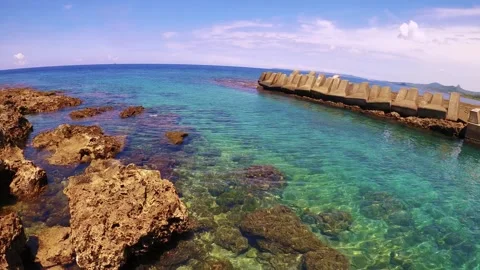 Horizontal pane view look out to ocean skyline horizon from coral reef rock shor Stock Footage 312346988