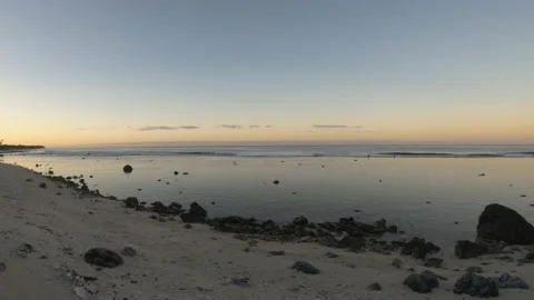 Horizontal pane view of ocean coastline bay sandy rocky beach with coconut trees Stock Footage 235320457