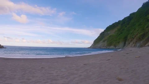 Horizontal pane view of peaceful beach side with ocean sea salt water pounding l Stock Footage 263017896