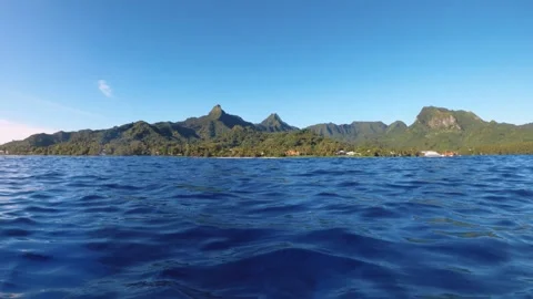 Horizontal pane view riding on boat look out to Avarua township with building su Stock Footage 259467324