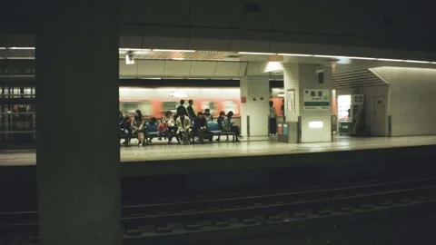 Horizontal pane view of underground train leaving Nanang Station with people pas Stock Footage 237251599
