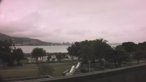 Horizontal pane view of urban cityscape look out across a river ocean to Bali in Stock-Footage 236229620