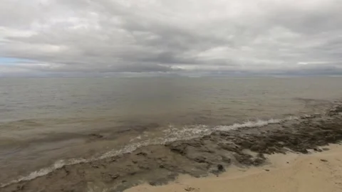 Horizontal pane view of wavy ocean salt sea water pounding turbulence onto the c Stock Footage 245442961