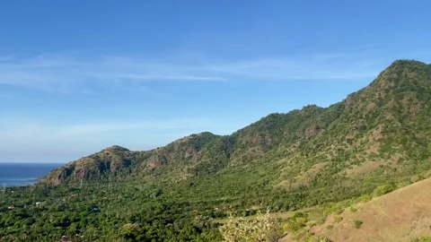 Horizontal Panning Green Mountain and Coastal Ocean View Bali Stock Footage 335941141