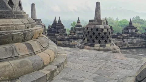 Horizontal Panning Shot of Ancient Perforated Stupas at Borobudur Temple Stock Footage 338275755