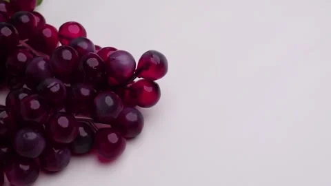 Horizontal panning shot of red grapes on white table Stock Footage 274243407