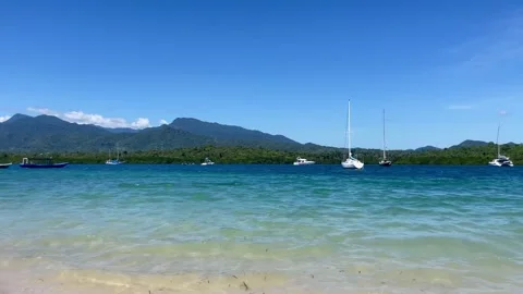 Horizontal Panning Turquoise Beach and Luxury Yachts Bali Stock Footage 335916045