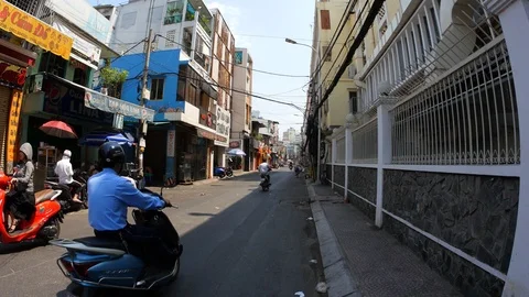 Horizontal panning view of busy traffic on streets of Ho Chi Minh City Stock Footage 106411016