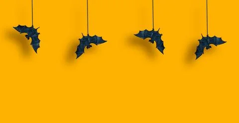 Horizontal pattern. Black bats in row are suspended with spread wings on ye.. Stock Photos