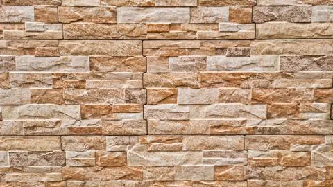 Horizontal pattern of rectangular beige and brown stone tiles Stock Photos