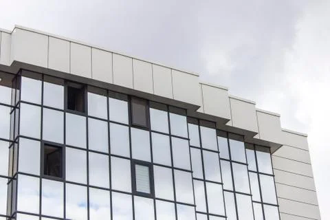 Horizontal perspective shot of multiple floor of a glazing facade building wi Stock Photos