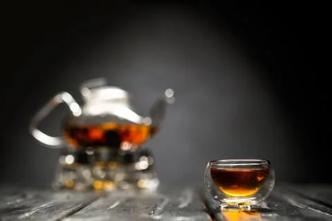 Horizontal photo of the tea set on a black background. Glass transparent teapot Stock Photos