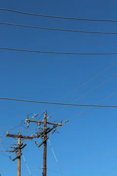 Horizontal power lines and vertical power poles background Stock Photos