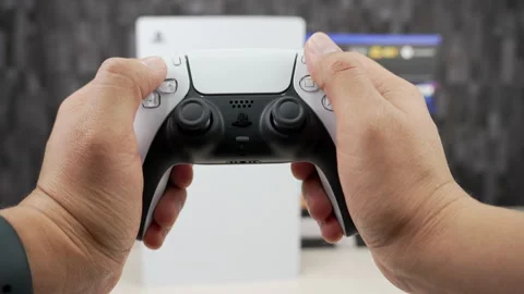 Horizontal PS5 Slim Standing in Front of Astro Bot and Gran Turismo 7 Box Stock Footage 344029661