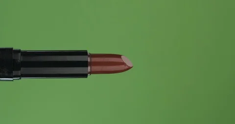 Horizontal rotation of an open red lipstick, on a green screen. Close-up. Stock Footage 127255242