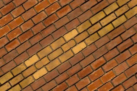 Horizontal row of yellow brown bricks symmetrical background design urban Stock Photos
