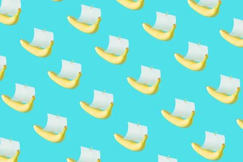 Horizontal seamless pattern of ship from banana with a paper sail against a past Stock Photos
