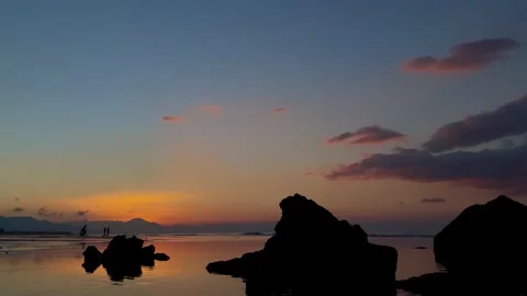 Horizontal shot of beach twilight sunset with rock silhouettes Bali 動画素材 343796730