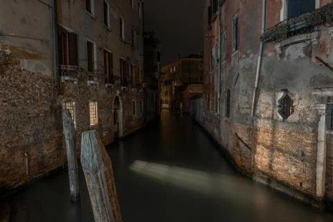 A horizontal shot of a canal between ancient apartment buildings in Venice, I Fotos de archivo