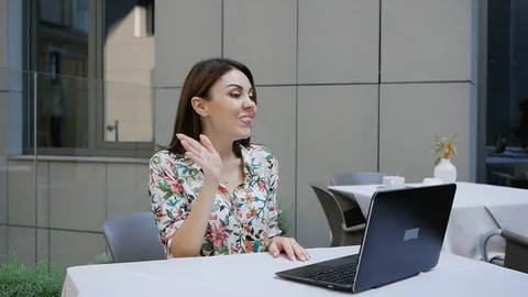 Horizontal shot of cheerful young woman makes video call, glad to communicate Video stock 102392053